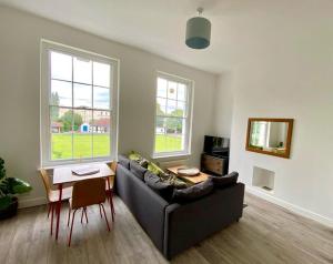 a living room with a couch and a table at Apartment 3 St Georges in Cheltenham