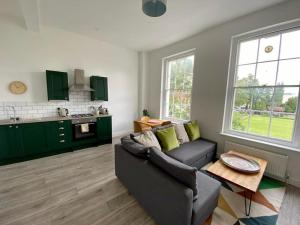 a living room with a couch and a table at Apartment 3 St Georges in Cheltenham