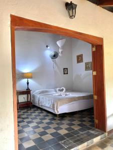 a bedroom with a bed and a checkered floor at ViaVia Leon in León