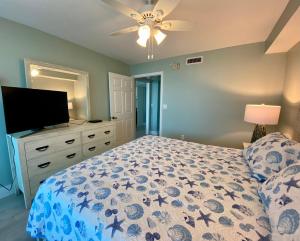 a bedroom with a bed and a flat screen tv at Lover's Key Resort by Check-In Vacation Rentals in Fort Myers Beach