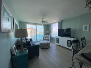 a living room with a couch and a television at Lover's Key Resort by Check-In Vacation Rentals in Fort Myers Beach