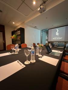 a conference room with a table with a laptop and wine glasses at Regal Pacific Puerto Madero in Buenos Aires