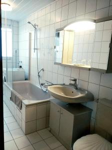 La salle de bains est pourvue d'un lavabo, d'une baignoire et de toilettes. dans l'établissement Urlaub nähe Badesee und Strand, à Berumbur