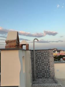 a bench on a balcony with a view of a city at Palazzo Palumbo in Procida