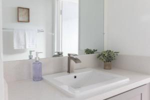 a bathroom sink with a purple soap bottle on it at 2BD/2BA Apartment in DT ALhambra in Alhambra +34 photos