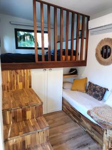 a room with a bunk bed in a house at Tiny house au lagon in Saint-Paul