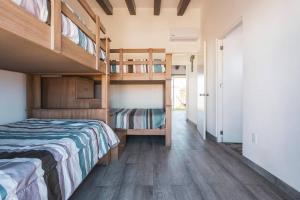 a bedroom with two bunk beds and a hallway at Villa Exclusiva en Cuernavaca: Casa con Alberca in Xochitepec +27 photos