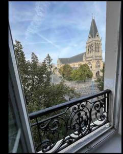 a view of a church from a balcony at appartement 93 proche stade de France in Saint-Denis