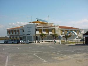 
a large building with a car parked in front of it at Aeromar in Faro
