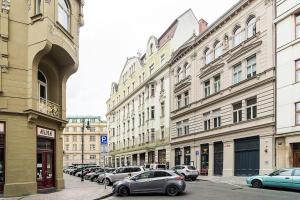 a row of buildings with cars parked on a street at Luxurious two-bedroom in the Old Town in Prague