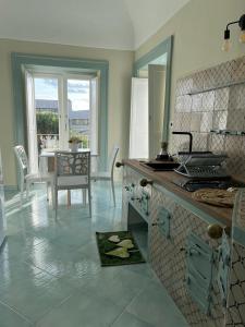 a kitchen with a table and a counter top at Palazzo Palumbo in Procida