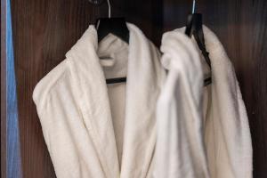 a group of white towels hanging on a rack at Tynecastle Park Hotel in Edinburgh