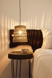 a table with a bowl on it next to a bed at Cove Fehendhoo in Fehendhoo