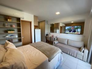 Et tv og/eller underholdning på FLAT TÉRREO - MANA BEACH EXPERIENCE - PRAIA DE MURO ALTO