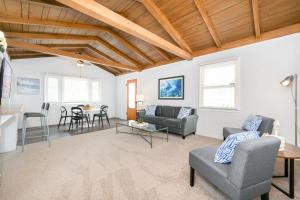 a living room with a couch and a table at 2 Bedroom steps to the beach in West Newport in Newport Beach