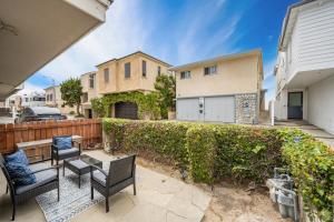 a backyard with chairs and a fence at 2 Bedroom steps to the beach in West Newport in Newport Beach