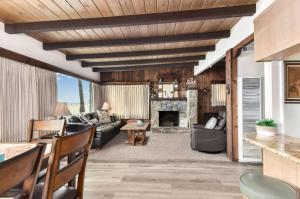 a living room with a couch and a fireplace at West Newport Duplex on the Sand with Patio-Sleeps 12 in Newport Beach