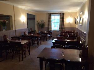 a restaurant with tables and chairs in a room at The Chase Inn in Bishops Frome