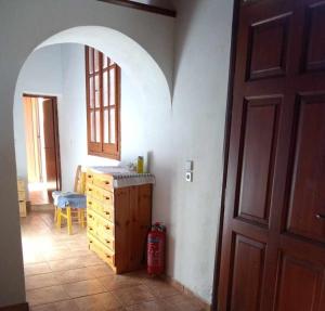 a room with a room with a door and a wooden cabinet at house FYNTIKAKH - SKALA in Anopoli Sfakion