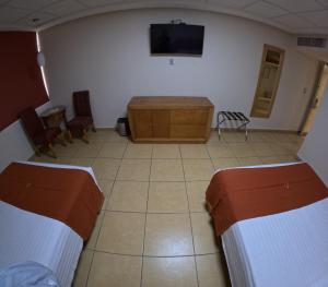 Postel nebo postele na pokoji v ubytování Hotel Yvette