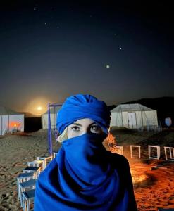 a woman with a blue towel on her face at Bivouac ZAGORA in Zagora