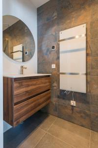 a bathroom with a sink and a mirror at Jean New Luxurious Home With Balconies Room 3 in Roosendaal