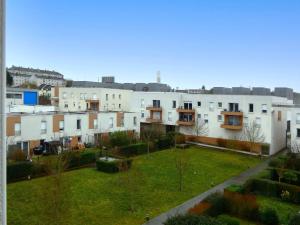 a group of white buildings with a green yard at Appartement spacieux avec rooftop et garages privés à 3 min de la gare d'Épernon - FR-1-581-129 in Épernon
