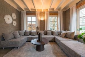 a living room with a large couch and a table at Stunning Catena Property in Boxtel
