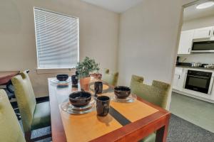 a dining room table with chairs and a kitchen at Triple Crown Lounge across from Casino condo in Hot Springs