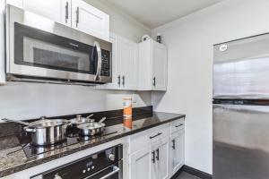 a kitchen with white cabinets and stainless steel appliances at Triple Crown Lounge across from Casino condo in Hot Springs