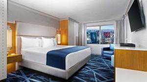 a hotel room with a bed and a large window at The STRAT Hotel, Casino & Tower in Las Vegas