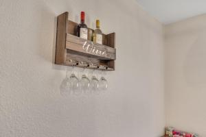 a wine rack with wine glasses on a wall at Triple Crown Lounge across from Casino condo in Hot Springs
