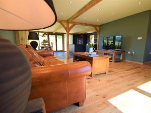 a living room with a leather couch and a tv at 1 Bed in Croyde 75270 in Marwood