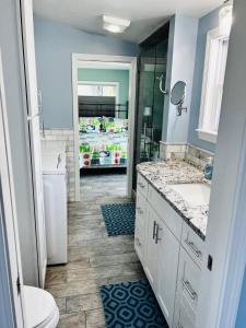 a bathroom with a sink and a refrigerator at All New Beautiful Priscilla Beach OceanView in Plymouth