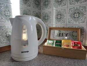 a white electric mixer sitting on a counter next to a box at Bed and Breakfast Cattinara in Trieste