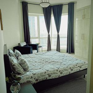a bedroom with a bed and a large window at Home stay - FEMALE GUEST ONLY -ممنوع دخول الرجال in Sharjah