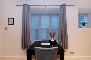 a dining room with a table and a window at One of a kind Historic 3 bedroom apartment in Aberdeen +18 photos