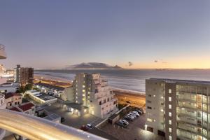 an aerial view of a city with the ocean and buildings at Ocean View B901 in Bloubergstrand