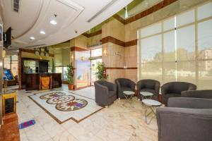 a lobby with chairs and a fireplace in a building at فندق منارة الكرام in Makkah