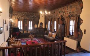 een woonkamer met een stenen muur bij Gaea Mont Chalet in Palaios Agios Athanasios