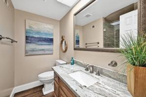 a bathroom with a sink and a toilet at Newport Paradise - Oceanfront Home by the Pier in Newport Beach
