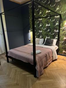 a bedroom with a canopy bed with a wall at Family Hostel Milano in Milan
