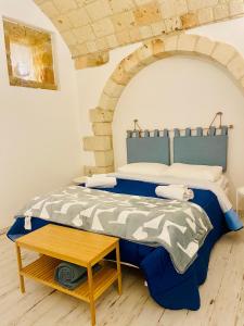 a bedroom with a bed and a table at La Bitta Suite in Brindisi