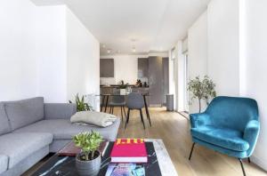 a living room with a couch and a blue chair at 2 Bedroom 2 Bathroom Cosy Apartment - Zone 1 - Central London in London