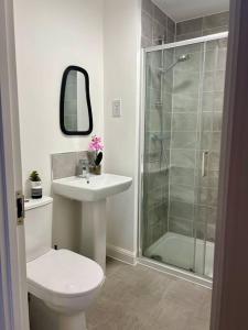 a bathroom with a toilet and a sink and a shower at Lotus Haus - Wyndale Living -W/off road Parking in Birmingham