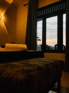 a bedroom with a bed and a window with a view at Cloud Nine in Kandy