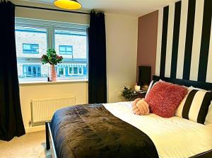 a bedroom with a large bed and a window at Lotus Haus - Wyndale Living -W/off road Parking in Birmingham