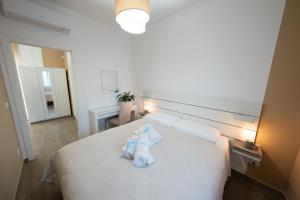 Postel nebo postele na pokoji v ubytování PALAZZO ENNIO
