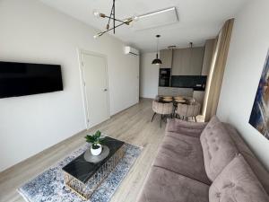 a living room with a couch and a table at Mano jura 2-Apartments in Palanga