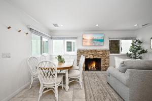 a living room with a table and a fireplace at 1313 S Coast Hwy in Laguna Beach
